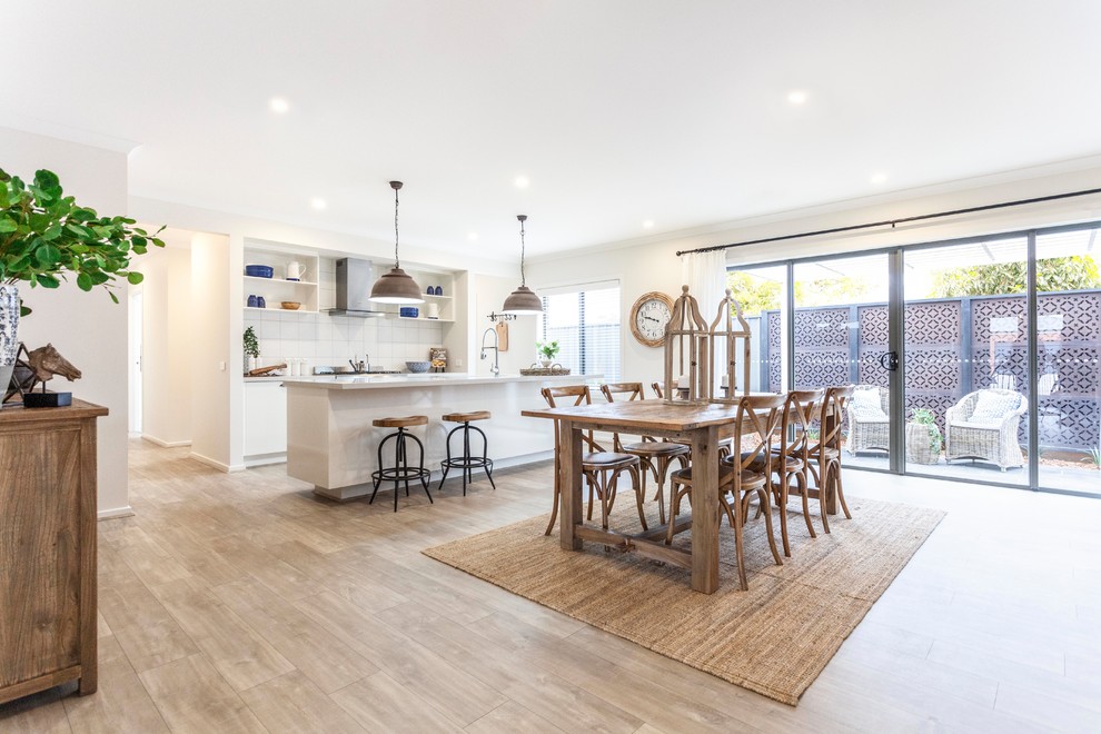 Design ideas for a transitional open plan dining in Melbourne with beige walls and light hardwood floors.