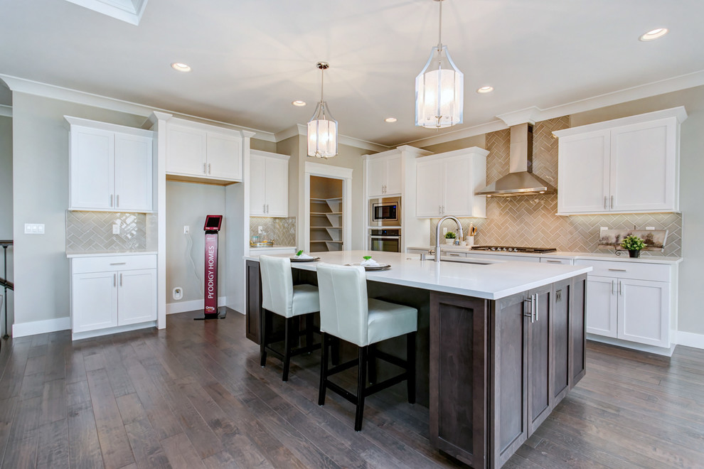 Open concept kitchen - large transitional l-shaped dark wood floor open concept kitchen idea in Seattle with an undermount sink, shaker cabinets, white cabinets, quartz countertops, gray backsplash, porcelain backsplash, stainless steel appliances, an island and white countertops