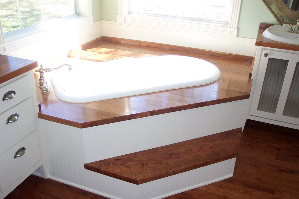 Photo of a traditional kids bathroom in Austin with a drop-in sink, wood benchtops, a claw-foot tub and dark hardwood floors.
