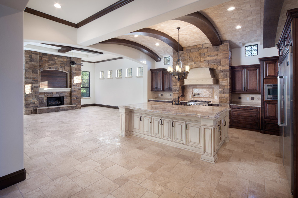 Design ideas for a large mediterranean open concept family room in Orlando with beige walls, travertine floors, a standard fireplace, a stone fireplace surround and a wall-mounted tv.