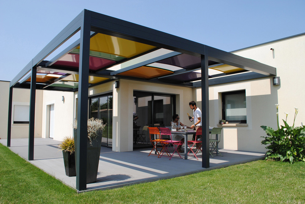 Mid-sized contemporary backyard patio in Angers with decking and a pergola.