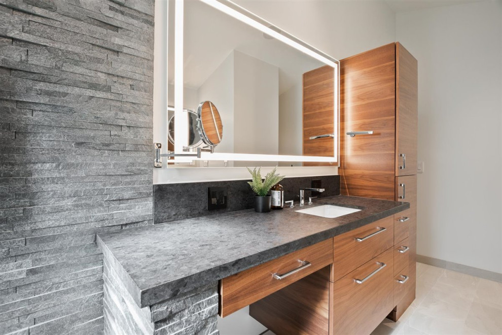 Inspiration for a large midcentury master bathroom in San Francisco with flat-panel cabinets, medium wood cabinets, a curbless shower, a one-piece toilet, gray tile, ceramic tile, wood-look tile, solid surface benchtops, an open shower, black benchtops, a floating vanity and vaulted.