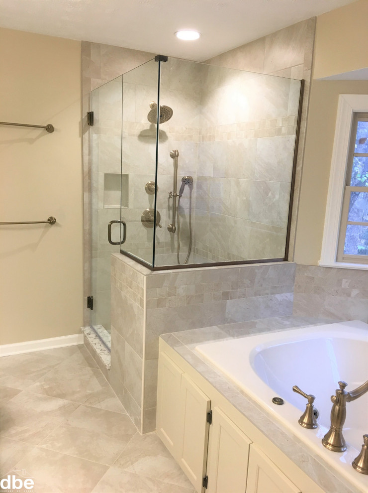 Photo of a mid-sized traditional master bathroom in Other with beige cabinets, a drop-in tub, a two-piece toilet, beige tile, ceramic tile, beige walls, ceramic floors, an undermount sink, engineered quartz benchtops, beige floor, a hinged shower door and beige benchtops.