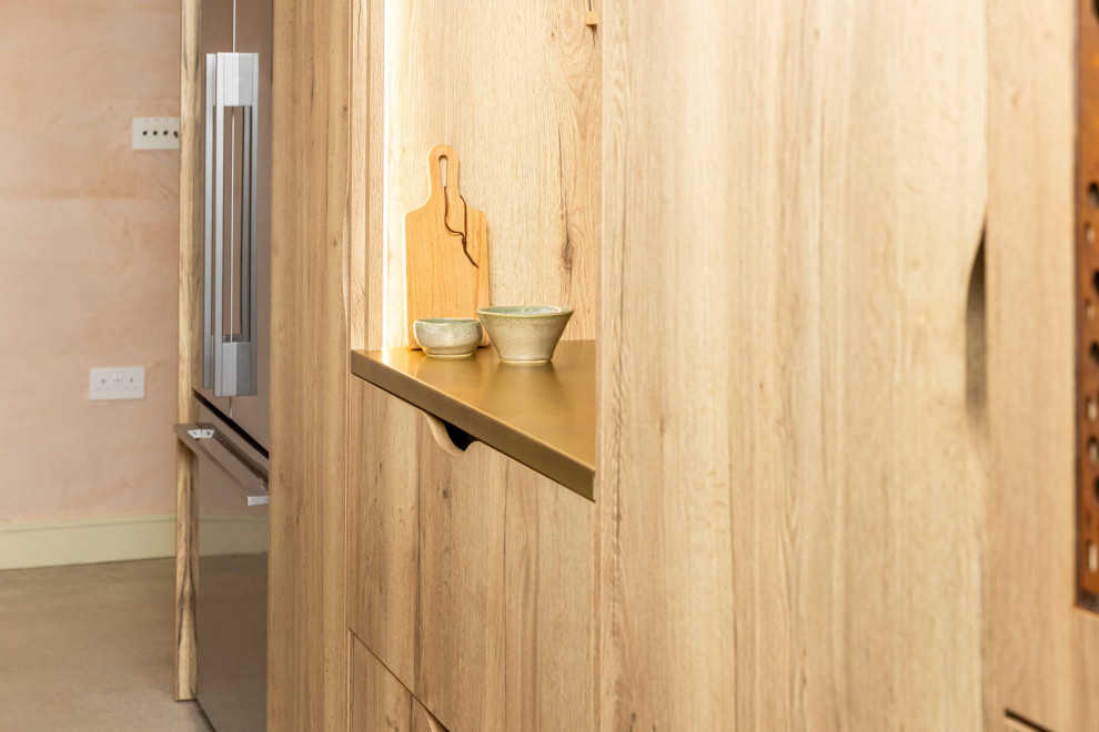Expansive industrial kitchen/dining room in Kent with brown walls, concrete flooring, grey floors and feature lighting.