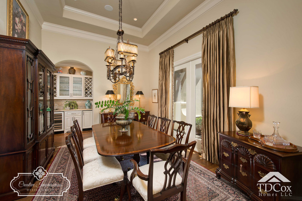 Inspiration for a large transitional separate dining room in Houston with beige walls, medium hardwood floors, no fireplace and brown floor.