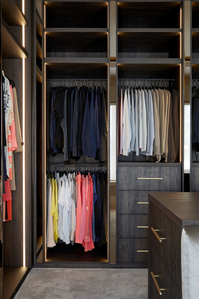 Inspiration for an expansive modern gender neutral dressing room in Hertfordshire with open cabinets, dark wood cabinets, carpet, grey floors, a coffered ceiling and a feature wall.