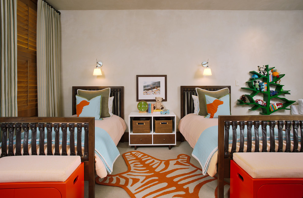 This is an example of a contemporary gender-neutral kids' bedroom for kids 4-10 years old in Denver with beige walls and carpet.