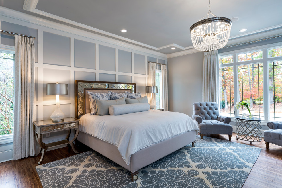 This is an example of a traditional master bedroom in Charlotte with grey walls, dark hardwood floors and brown floor.
