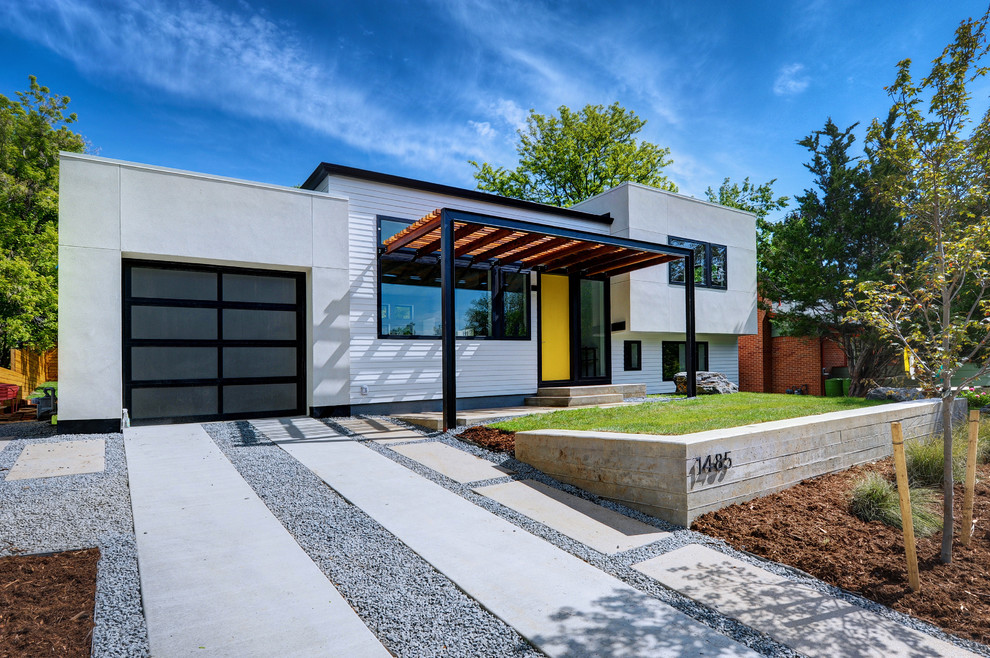 Contemporary split-level white house exterior in Denver with mixed siding and a flat roof.