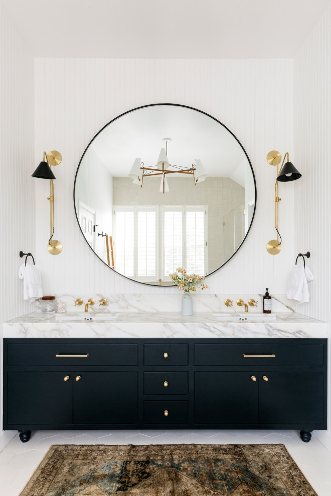 This is an example of a large country master bathroom in San Francisco with beaded inset cabinets, blue cabinets, a claw-foot tub, a curbless shower, a two-piece toilet, white tile, ceramic tile, white walls, cement tiles, an undermount sink, marble benchtops, white floor, a hinged shower door, white benchtops, an enclosed toilet, a double vanity, a built-in vanity, vaulted and panelled walls.