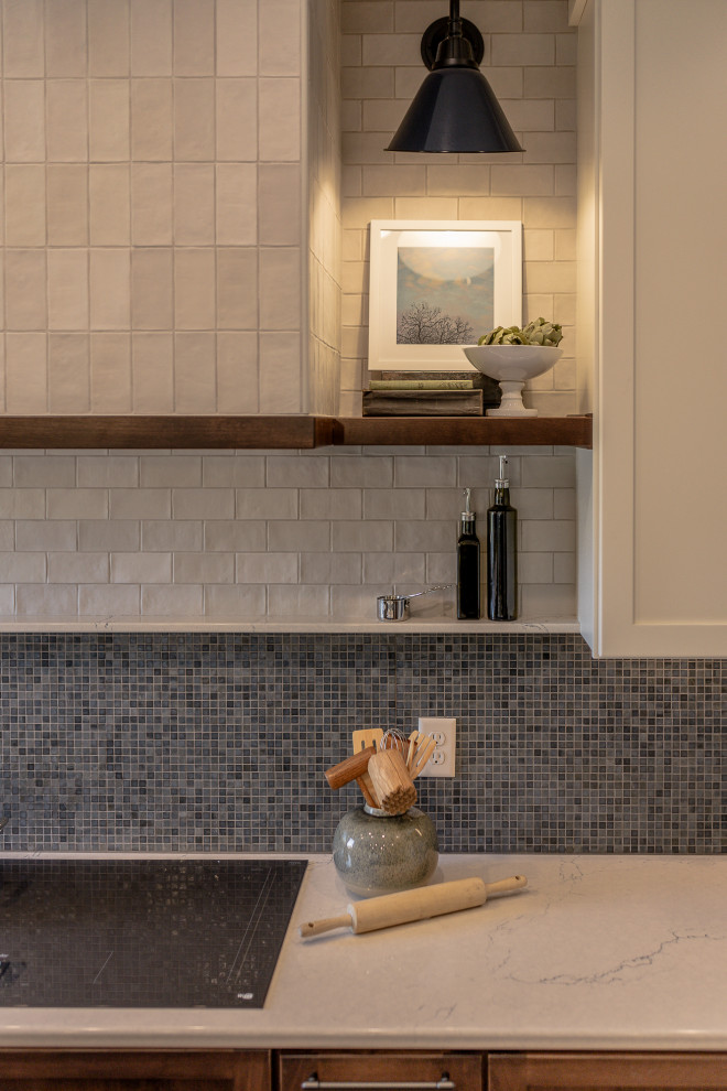 Eat-in kitchen - mid-sized transitional l-shaped medium tone wood floor and brown floor eat-in kitchen idea with an undermount sink, recessed-panel cabinets, dark wood cabinets, quartz countertops, blue backsplash, mosaic tile backsplash, stainless steel appliances, an island and white countertops
