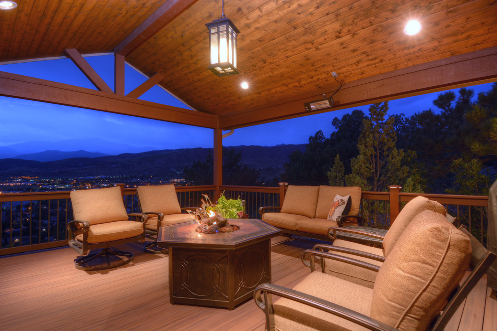 Example of a small backyard outdoor kitchen deck design in Denver with a roof extension