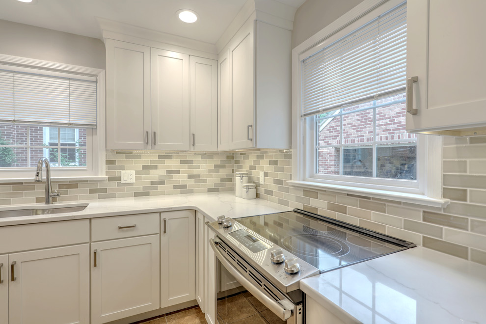 Small transitional ceramic tile and beige floor kitchen photo with a double-bowl sink, shaker cabinets, quartz countertops, beige backsplash, ceramic backsplash, stainless steel appliances and white countertops