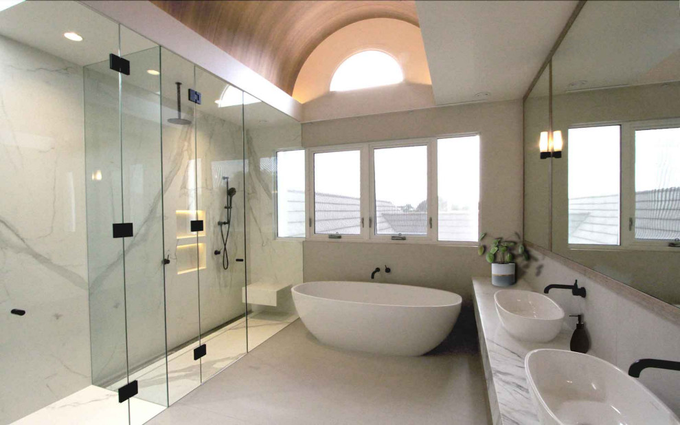 Inspiration for a mid-sized contemporary master bathroom in Melbourne with flat-panel cabinets, a freestanding tub, white tile, marble, marble benchtops, a hinged shower door, white benchtops, a double vanity, a floating vanity and vaulted.