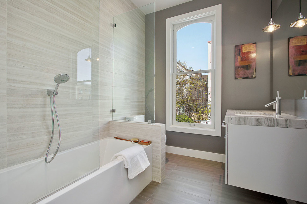Inspiration for a transitional 3/4 beige tile and gray tile gray floor bathroom remodel in San Francisco with flat-panel cabinets, gray cabinets, gray walls, an undermount sink and marble countertops