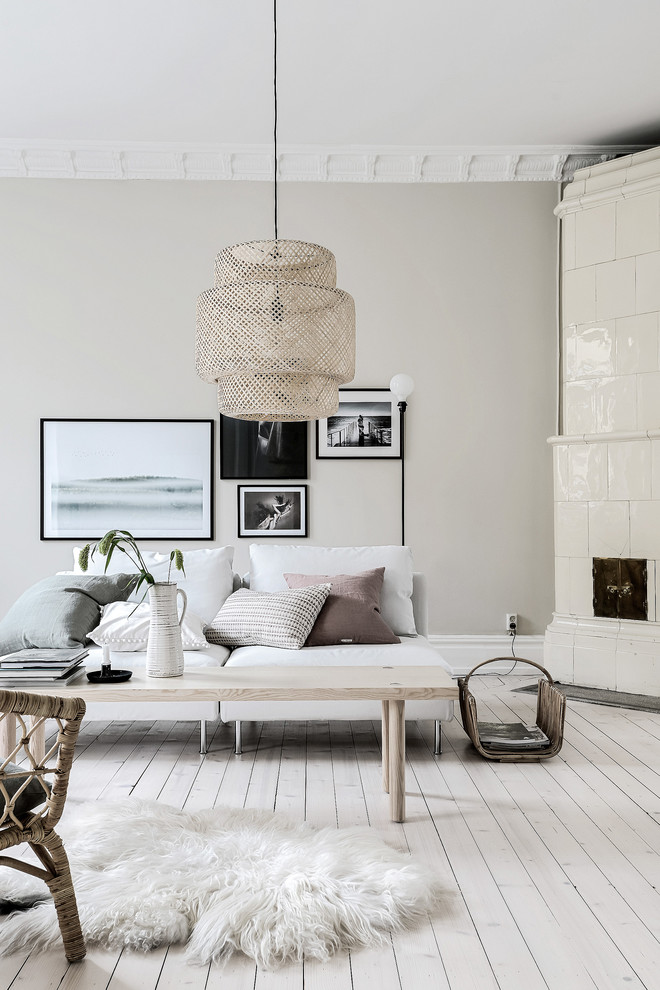 This is an example of a large traditional living room in Gothenburg with beige walls and light hardwood floors.
