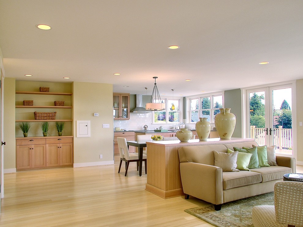 Traditional open concept family room in Seattle with beige walls, light hardwood floors and beige floor.