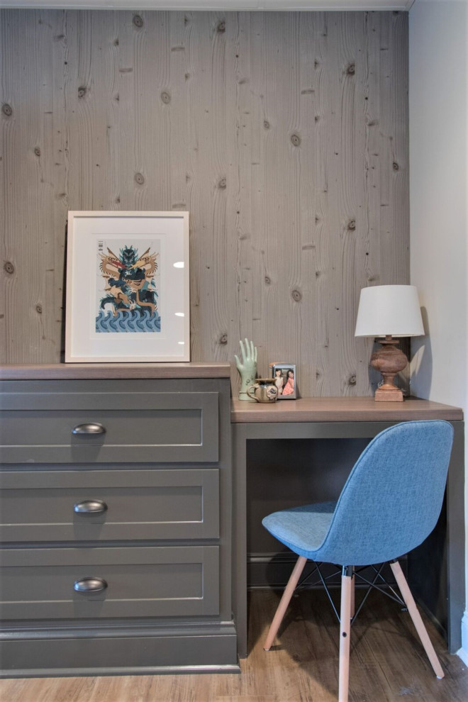 This is an example of a small transitional gender-neutral kids' room in Nashville with white walls, medium hardwood floors and brown floor.