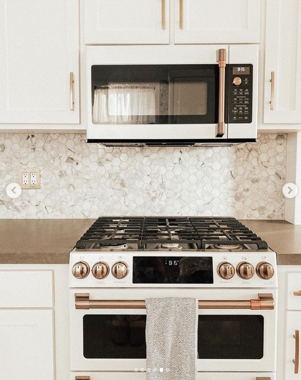 Example of a mid-sized transitional ceramic tile and beige floor eat-in kitchen design in San Francisco with a farmhouse sink, shaker cabinets, white cabinets, quartz countertops, multicolored backsplash, mosaic tile backsplash, white appliances and gray countertops