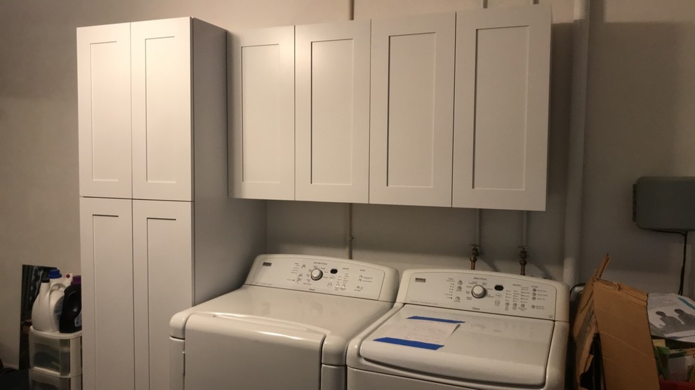 Design ideas for a mid-sized transitional single-wall utility room in Jacksonville with shaker cabinets, white cabinets, grey walls and a side-by-side washer and dryer.