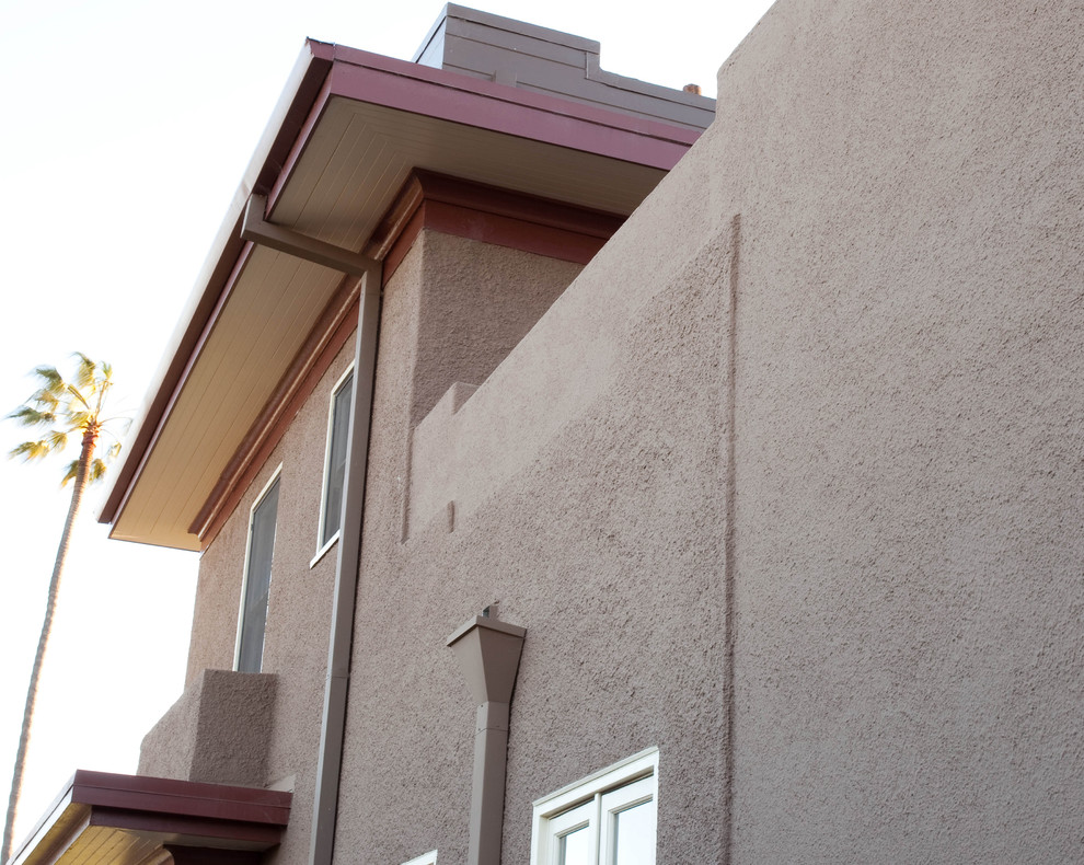 Arts and crafts two-storey stucco brown exterior in San Diego with a flat roof.