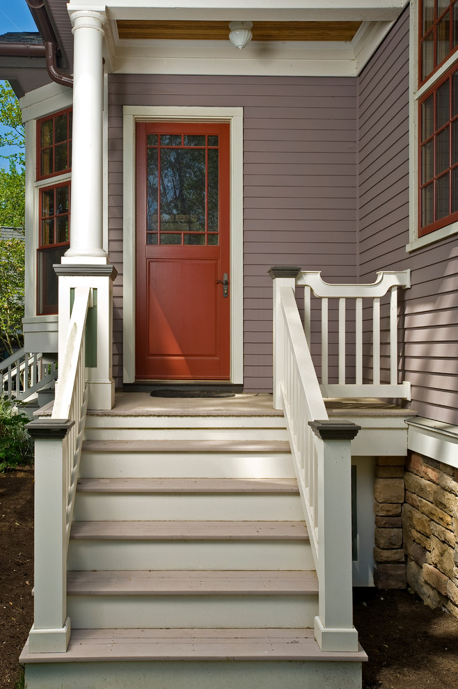 This is an example of a mid-sized traditional front door in New York with purple walls, light hardwood floors, a single front door and a red front door.