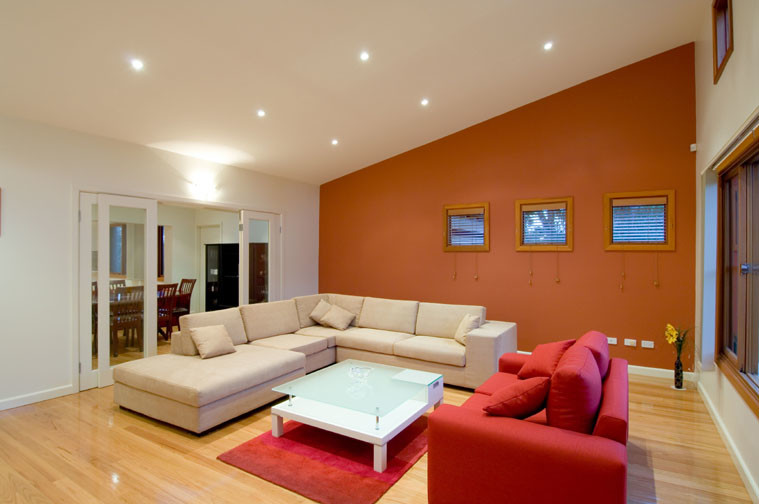 Mid-sized modern formal enclosed living room in Sydney with white walls, light hardwood floors, no fireplace and no tv.