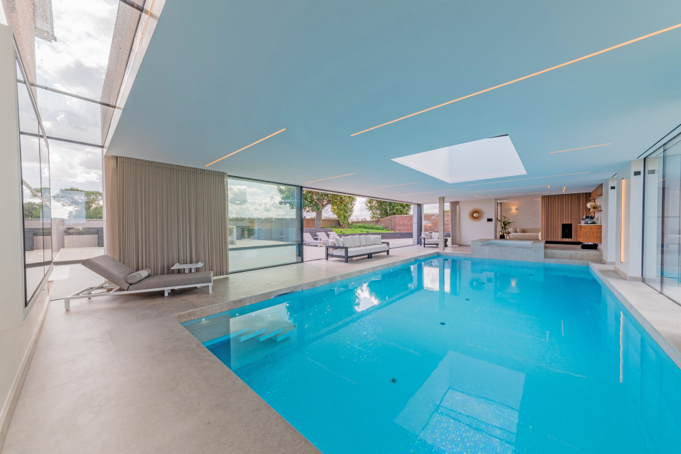 This is an example of a large contemporary swimming pool in Kent.