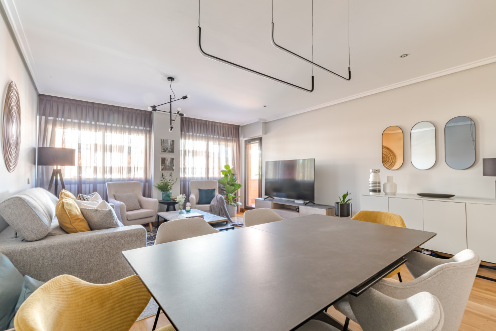 Design ideas for a medium sized modern dining room in Madrid with grey walls and medium hardwood flooring.