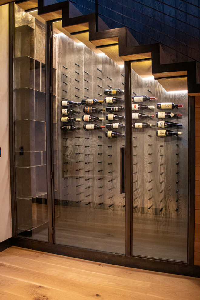 Design ideas for a traditional wine cellar in Other with storage racks and painted wood flooring.