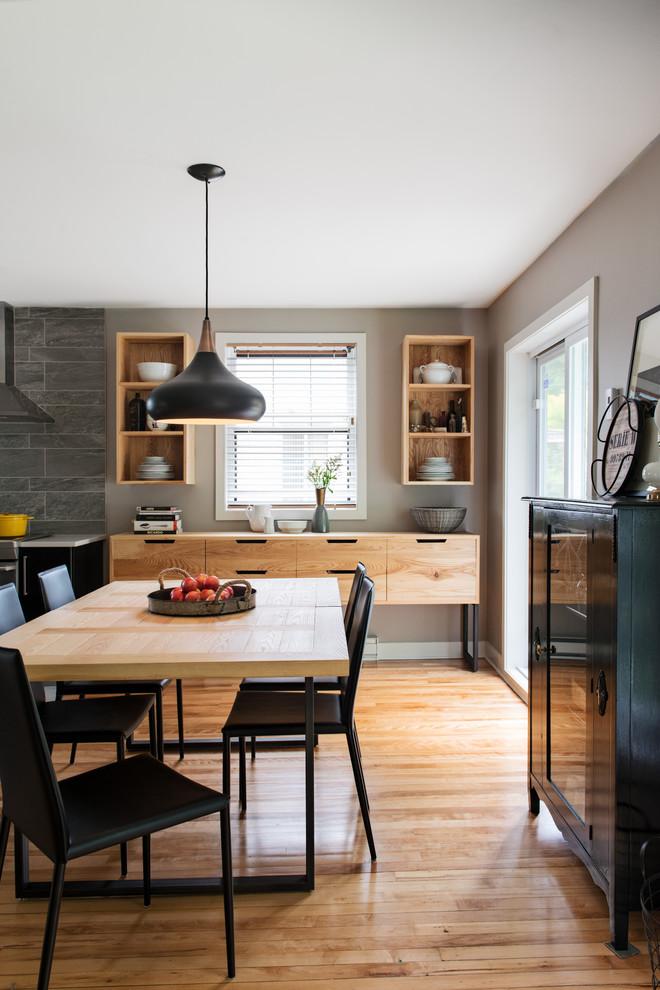 Photo of a contemporary dining room in Montreal with grey walls.