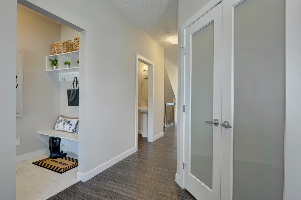 Foyer - mid-sized transitional vinyl floor and brown floor foyer idea in Edmonton with beige walls and a white front door