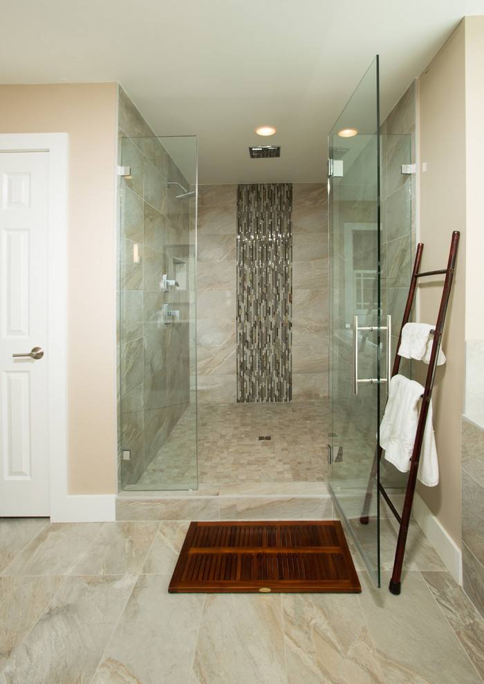 Photo of a large contemporary master bathroom in DC Metro with flat-panel cabinets, medium wood cabinets, a drop-in tub, an alcove shower, a two-piece toilet, beige walls, an integrated sink, beige tile, ceramic tile, ceramic floors, beige floor and a hinged shower door.