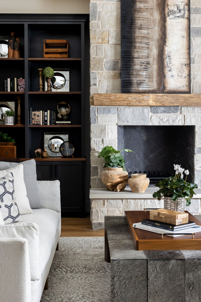 Inspiration for a large transitional open concept living room in Dallas with white walls, medium hardwood floors, a standard fireplace, a built-in media wall and brown floor.