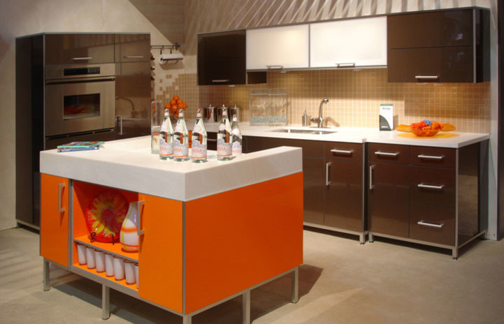 Example of a mid-sized mid-century modern l-shaped concrete floor and gray floor kitchen design in Santa Barbara with a double-bowl sink, flat-panel cabinets, brown cabinets, quartz countertops, brown backsplash, porcelain backsplash, stainless steel appliances, an island and white countertops