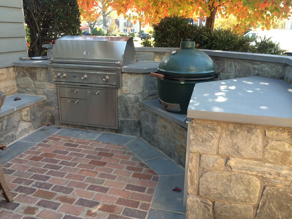Photo of a small arts and crafts courtyard patio in DC Metro with an outdoor kitchen and natural stone pavers.