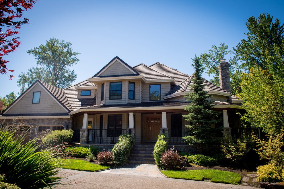 Example of a beige two-story mixed siding house exterior design in Portland