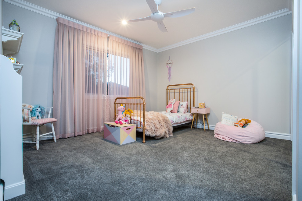 Design ideas for a mid-sized traditional kids' room for girls in Brisbane with beige walls, carpet and grey floor.