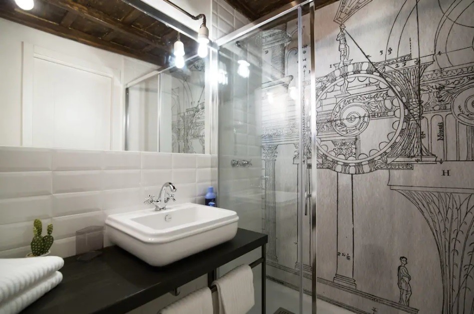 This is an example of a small industrial powder room in Rome with open cabinets, distressed cabinets, a one-piece toilet, white tile, terra-cotta tile, white walls, porcelain floors, a vessel sink and green floor.