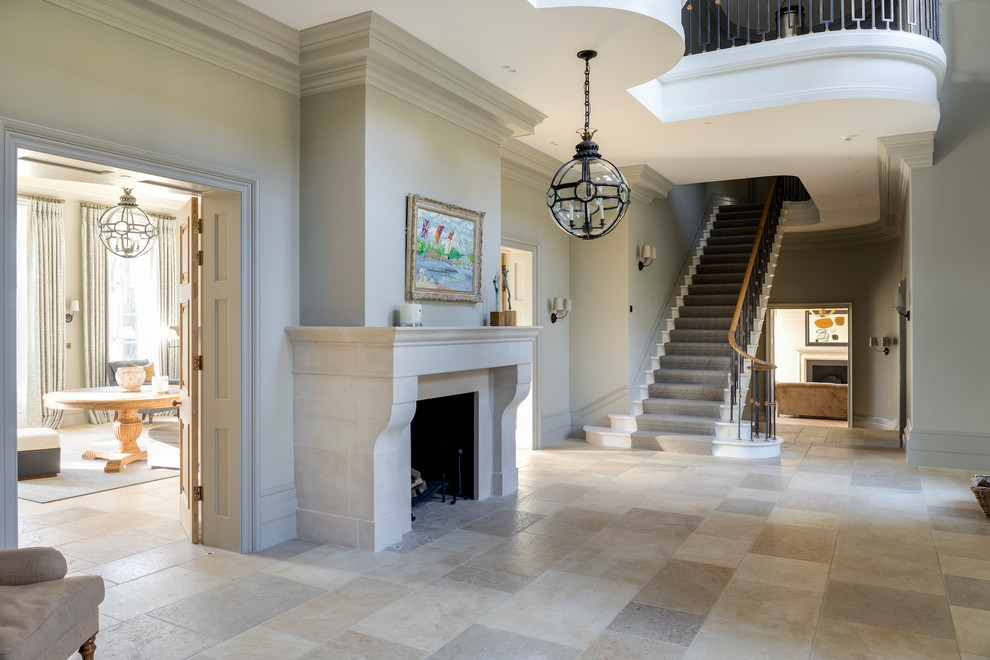 This is an example of a large traditional hallway in Wiltshire with limestone floors, grey walls and grey floor.