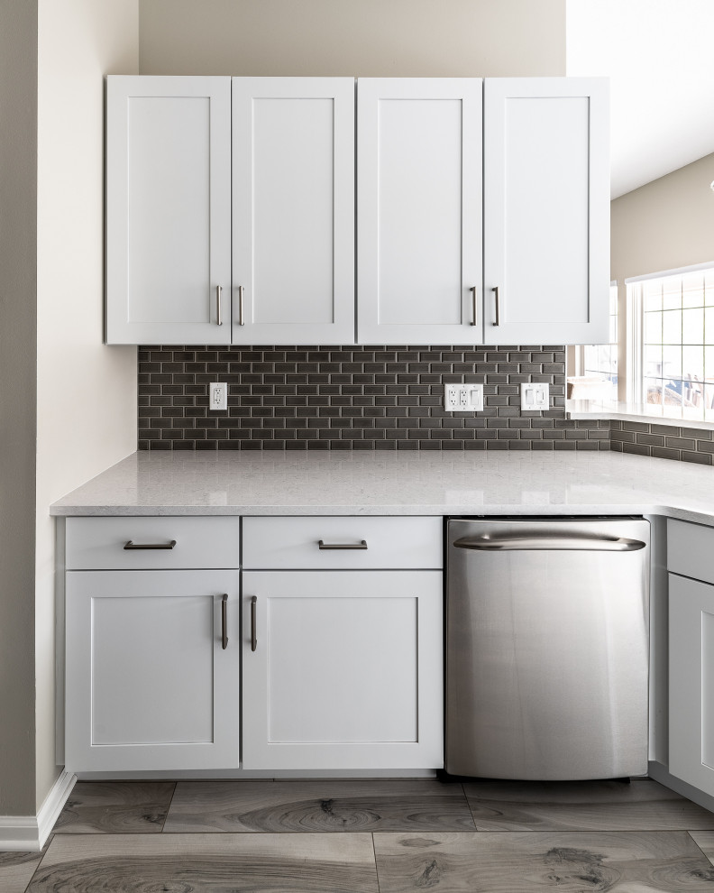 Inspiration for a mid-sized transitional galley porcelain tile and multicolored floor eat-in kitchen remodel with an undermount sink, recessed-panel cabinets, white cabinets, quartz countertops, gray backsplash, ceramic backsplash, stainless steel appliances, a peninsula and white countertops