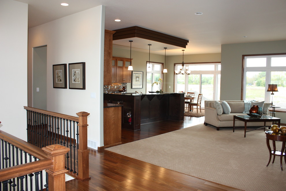 Inspiration for a mid-sized transitional l-shaped medium tone wood floor home design remodel with an undermount sink, recessed-panel cabinets, medium tone wood cabinets, granite countertops, multicolored backsplash, mosaic tile backsplash, stainless steel appliances and an island