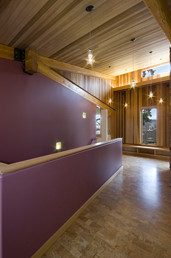 This is an example of a mid-sized modern hallway in Seattle with purple walls and medium hardwood floors.