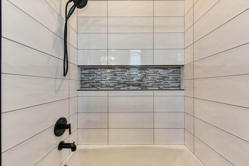 This is an example of a small modern 3/4 bathroom in Sacramento with a drop-in tub, a shower/bathtub combo and ceramic tile.