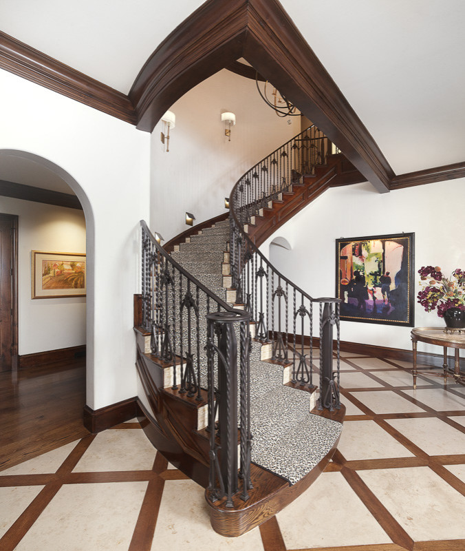 Photo of a large eclectic wood curved metal railing staircase in Dallas with wood risers.