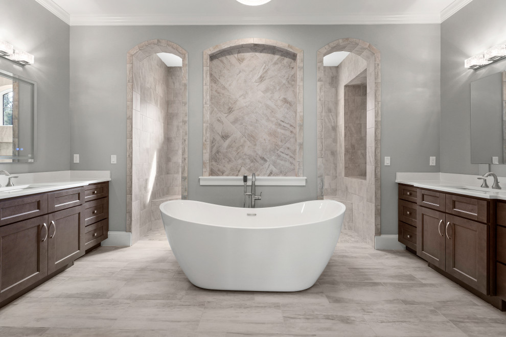 Design ideas for a large transitional master bathroom in Jacksonville with recessed-panel cabinets, grey cabinets, a freestanding tub, an open shower, gray tile, porcelain tile, grey walls, porcelain floors, an undermount sink, engineered quartz benchtops, grey floor, an open shower, white benchtops, a niche, a double vanity and a built-in vanity.