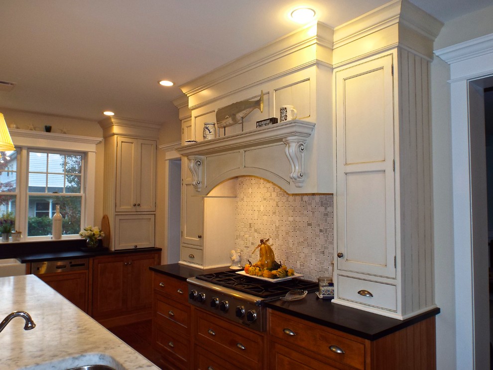 This is an example of an expansive traditional galley eat-in kitchen in New York with with island, beaded inset cabinets, distressed cabinets, granite benchtops, grey splashback, stone tile splashback, stainless steel appliances, a farmhouse sink and medium hardwood floors.