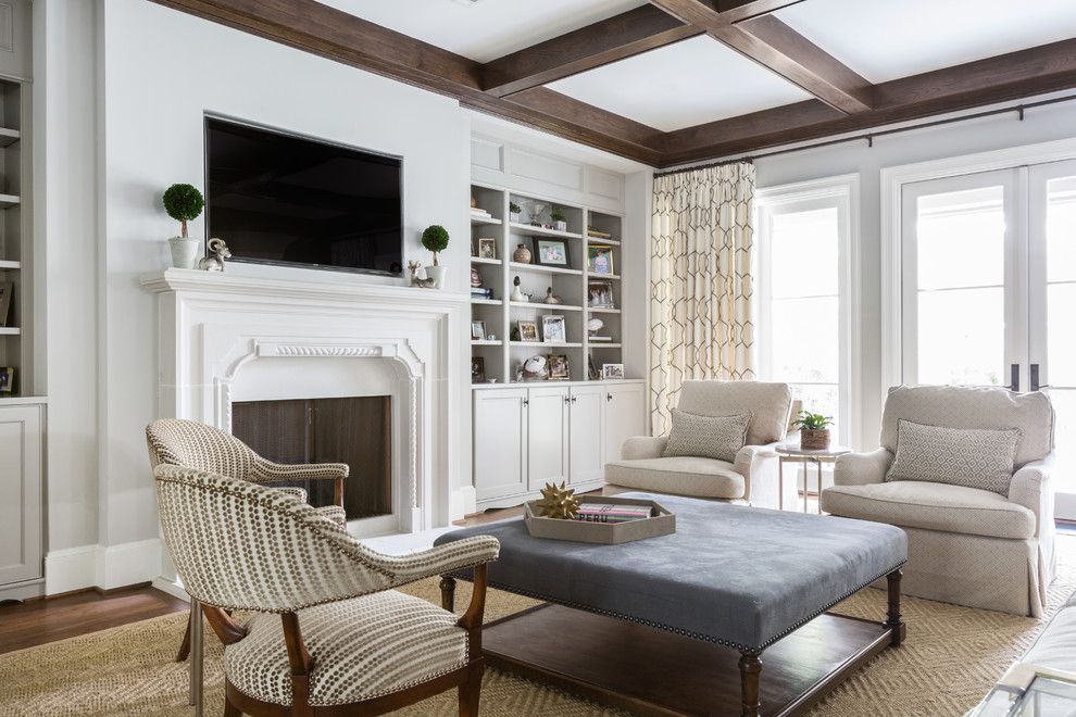 Inspiration for a traditional family room in Houston with grey walls, a standard fireplace, a wall-mounted tv and grey floor.