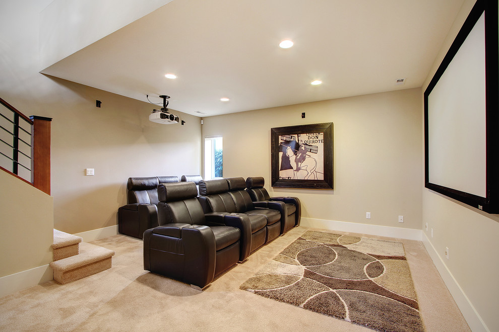 Design ideas for a mid-sized transitional open concept home theatre in Seattle with beige walls, carpet, a projector screen and beige floor.