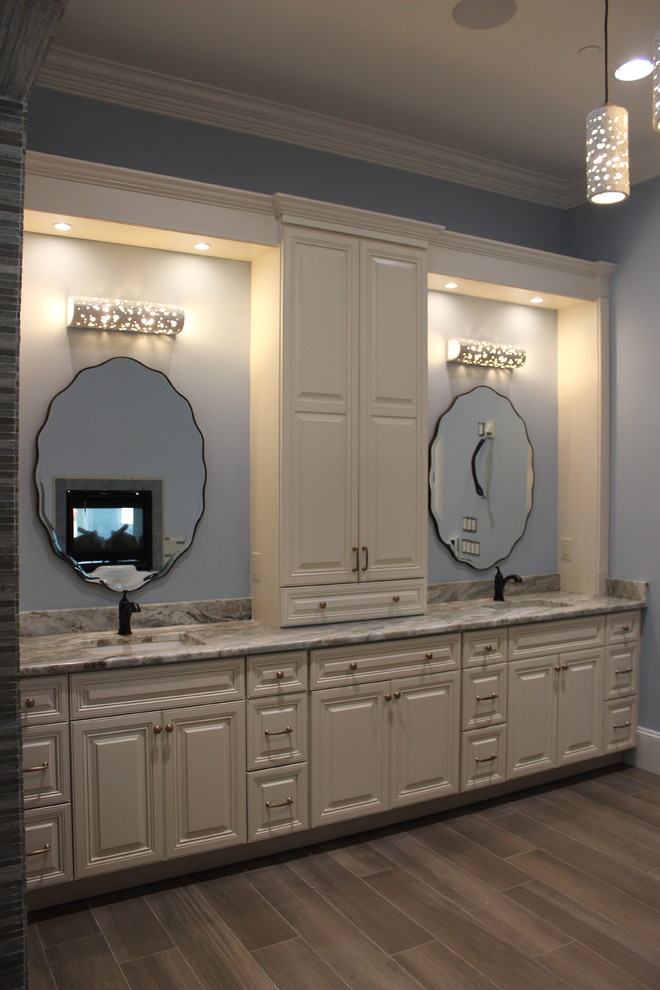 Photo of a mid-sized traditional master bathroom in Miami with raised-panel cabinets, beige cabinets, blue tile, an undermount sink, granite benchtops and multi-coloured benchtops.
